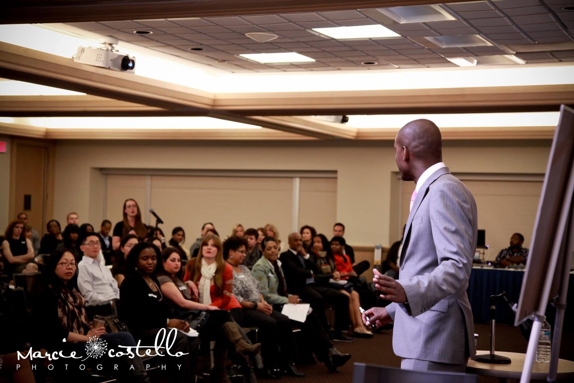 Coach Noel Walrond speaking to a full room